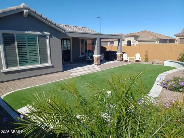 a view of a house with a backyard porch and sitting area