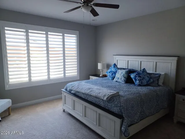 a bed sitting in a bedroom next to a window