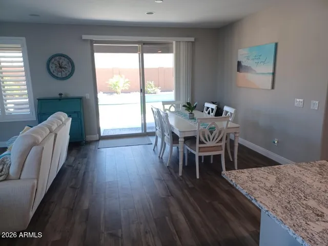 a dining room with furniture window and wooden floor