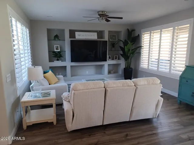 a living room with furniture fireplace and flat screen tv