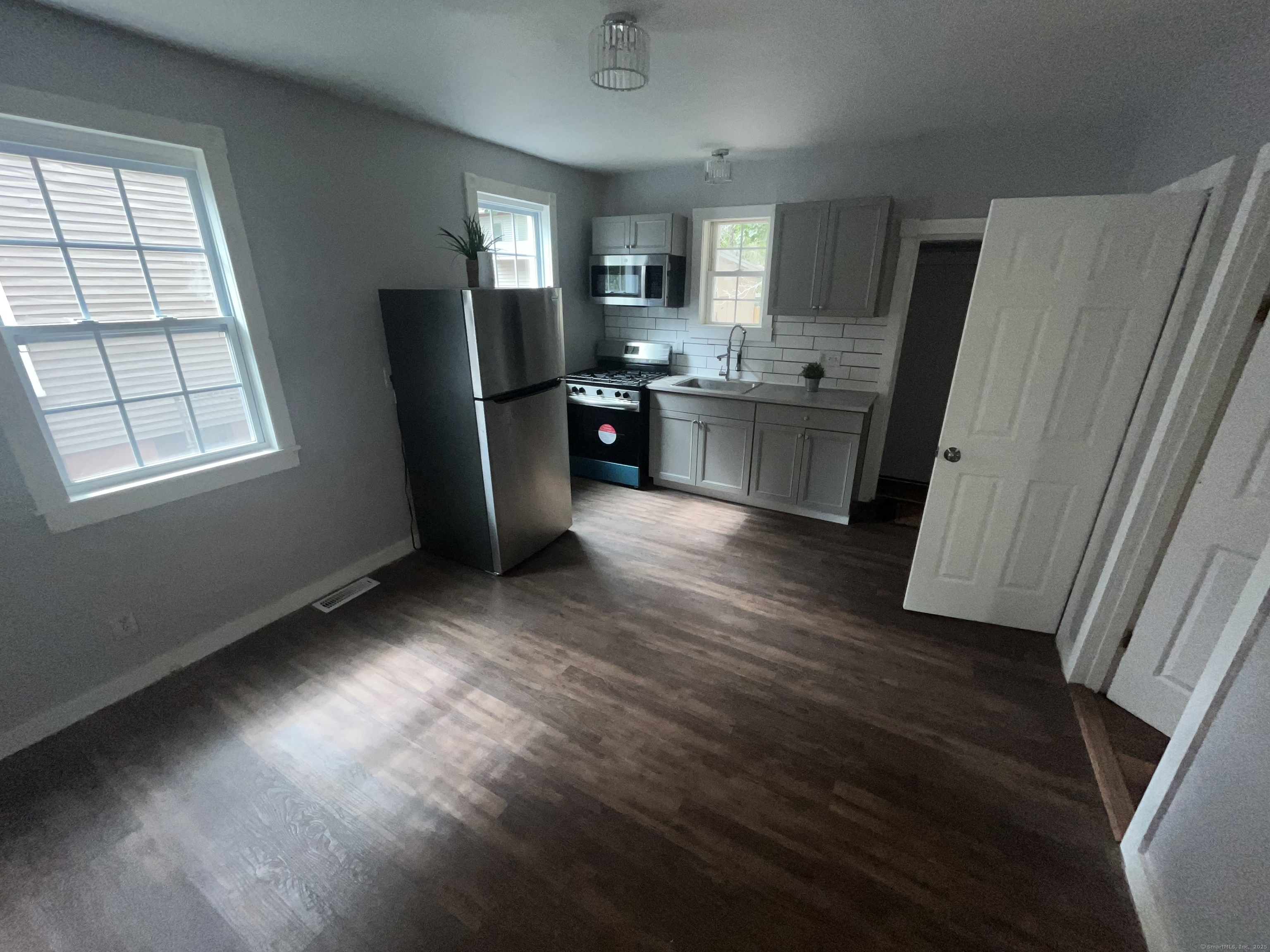 212 Newhall Street, Unit 1 New Haven, CT 06511 - Photo 2 of 6 a kitchen with stainless steel appliances granite countertop a refrigerator sink and cabinets