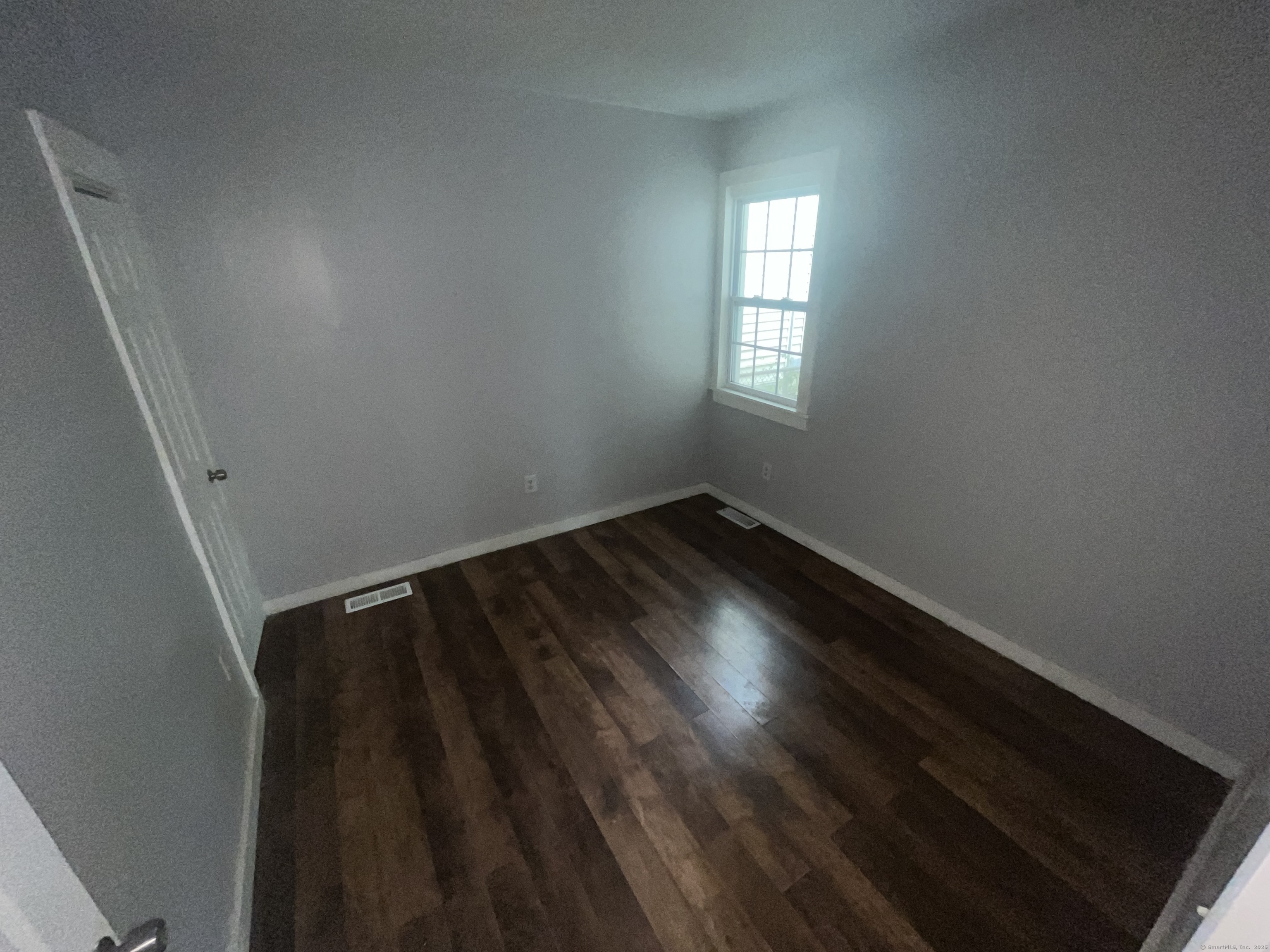 212 Newhall Street, Unit 1 New Haven, CT 06511 - Photo 5 of 6 an empty room with wooden floor and windows
