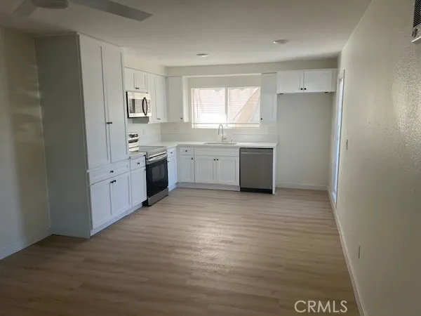 a large white kitchen with a window