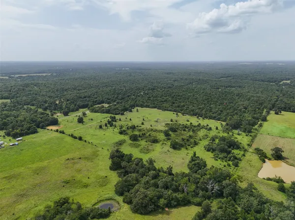 an aerial view of a houses with a yard