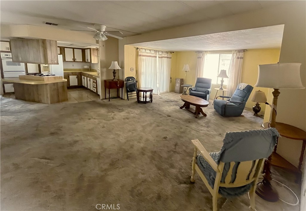 9391 California Avenue, Unit 109 Riverside, CA 92503 - Photo 4 of 9 a living room with furniture and a dining table