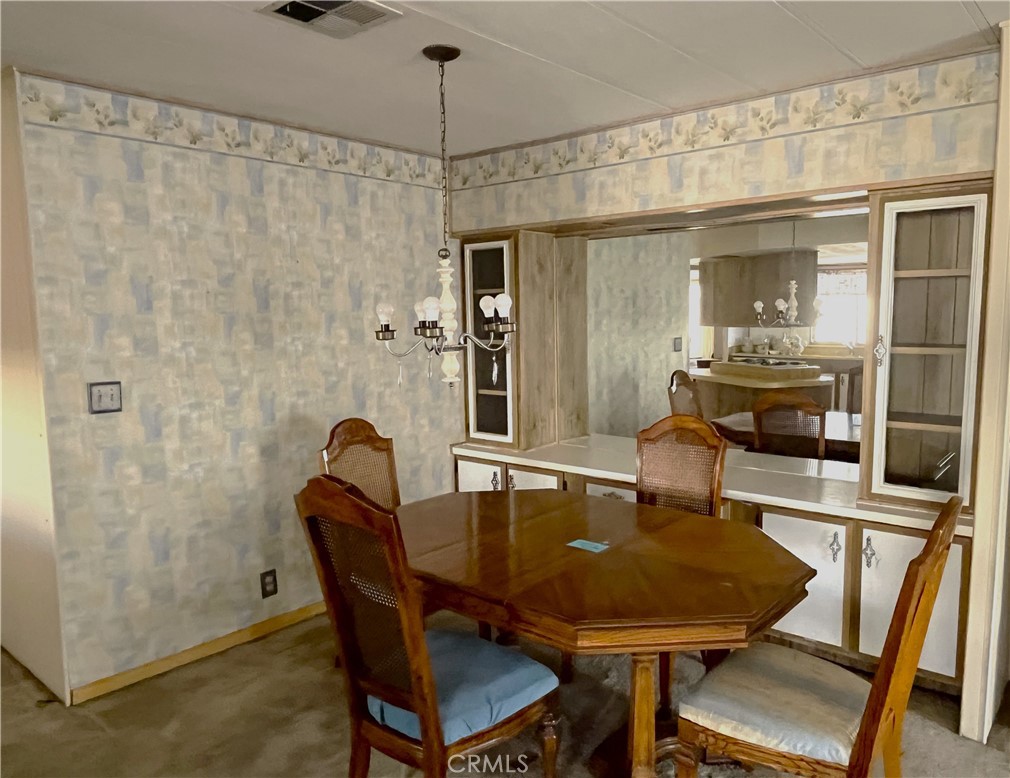 9391 California Avenue, Unit 109 Riverside, CA 92503 - Photo 5 of 9 a dining room with furniture and window