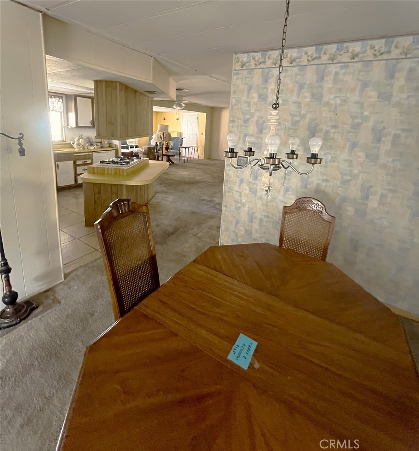 9391 California Avenue, Unit 109 Riverside, CA 92503 - Photo 6 of 9 a bedroom with a bed and chandelier