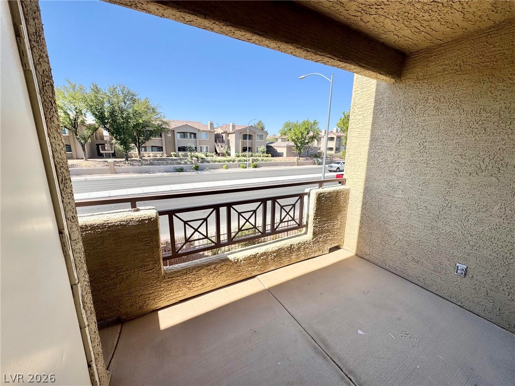 8070 West Russell Road, Unit 2121 Las Vegas, NV 89113 - Photo 20 of 22 A private balcony offers serene views of the surrounding neighborhood and tree-lined street.