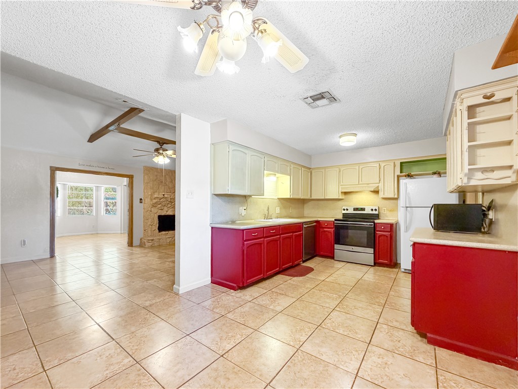 910 Twite Circle Corpus Christi, TX 78418 - Photo 10 of 39 a large kitchen with stainless steel appliances and cabinets