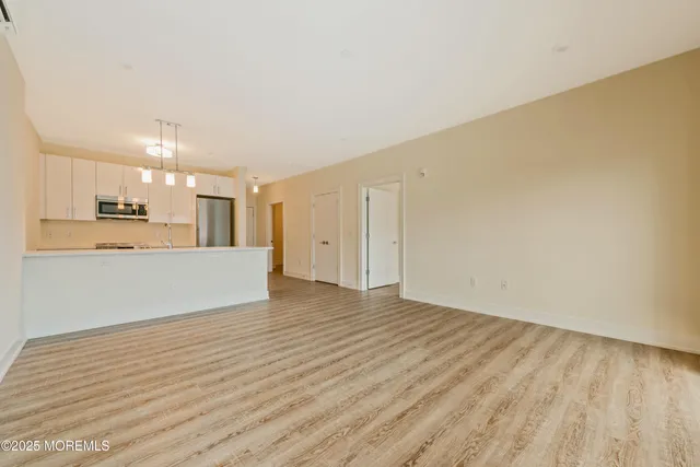 a view of a kitchen with wooden floor and a sink