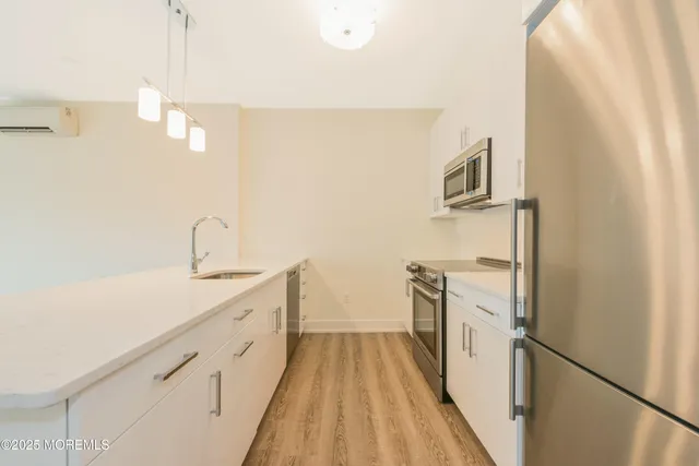 a kitchen with a sink and refrigerator