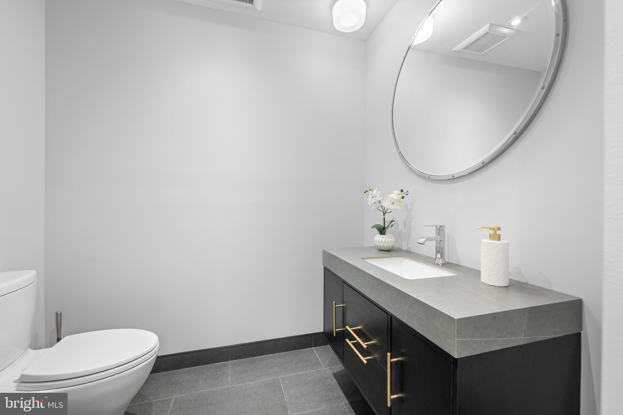 850 Lesley Road Villanova, PA 19085 - Photo 13 of 37 a bathroom with a sink a toilet and a mirror