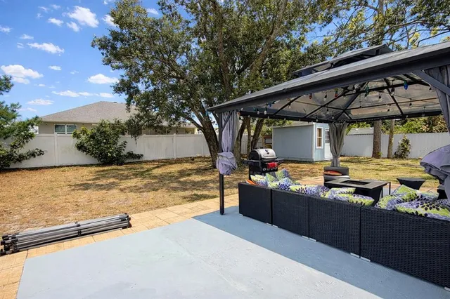 a view of a backyard with sitting area