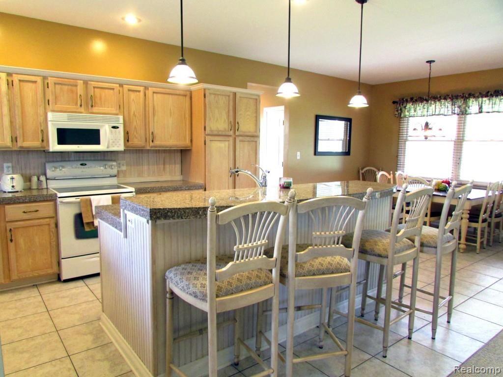 1699 Horton Lake Road Lapeer, MI 48446 - Photo 12 of 54 Kitchen with Granite Counters and Island Bar