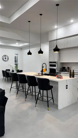 a kitchen with stainless steel appliances a stove a refrigerator and a microwave