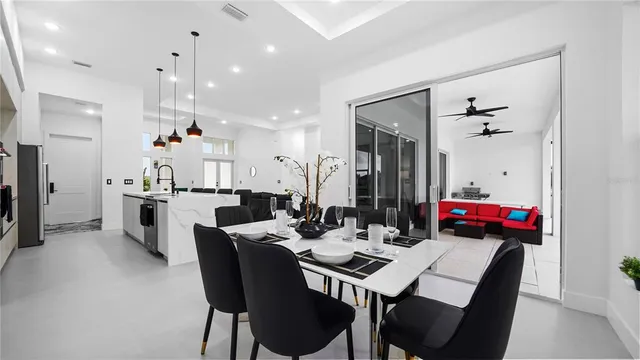 a living room with furniture and floor to ceiling windows