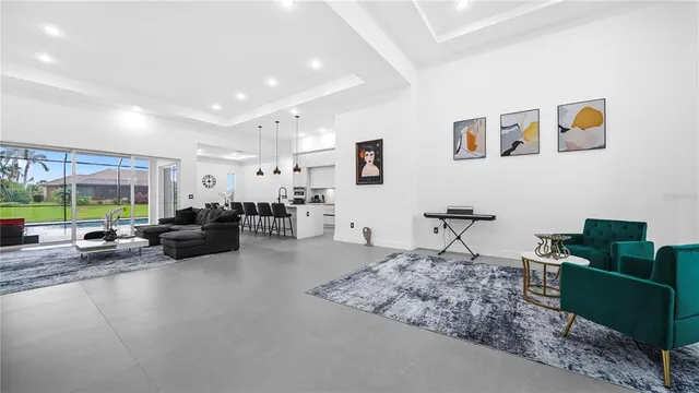 a living room with furniture large window and a table