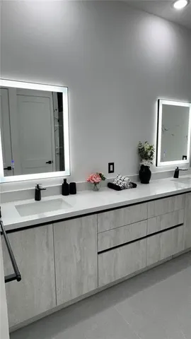 a view of a livingroom with wooden floor and a bathroom space