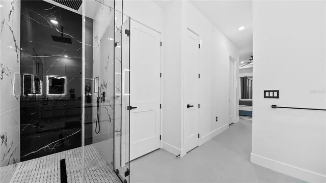a bathroom with a sink toilet vanity and shower