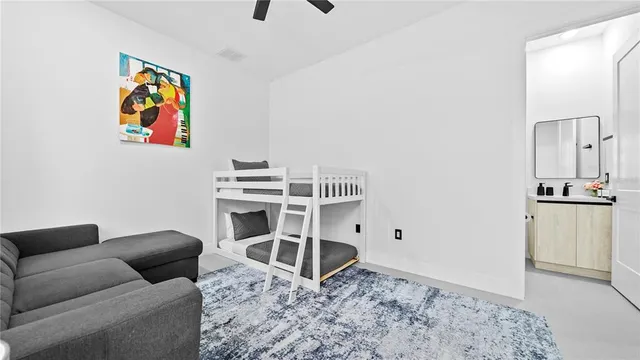 a living room with couch and a floor to ceiling window