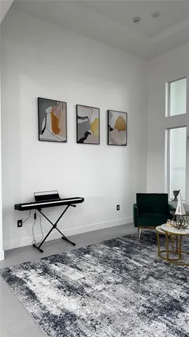 a living room with furniture and a dining table with wooden floor