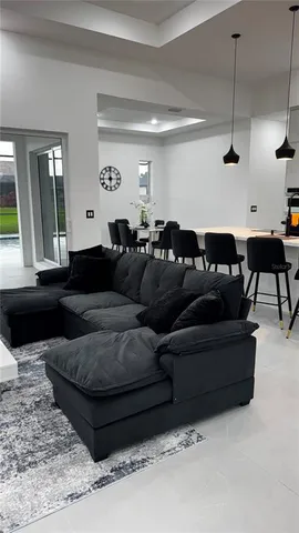 a living room with furniture and a floor to ceiling window