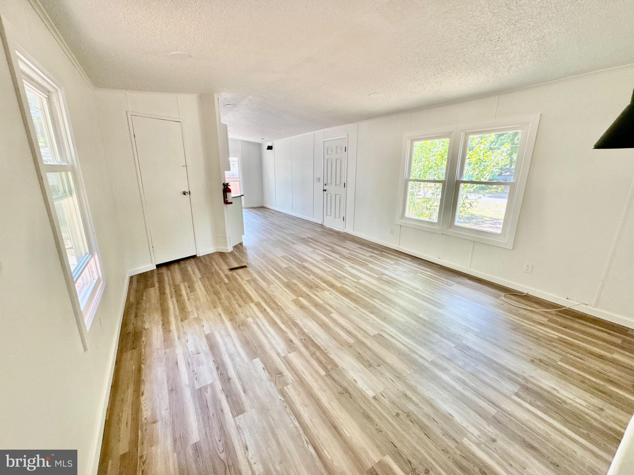 448 Evergreen Road Millville, NJ 08332 - Photo 14 of 25 an empty room with wooden floor and windows