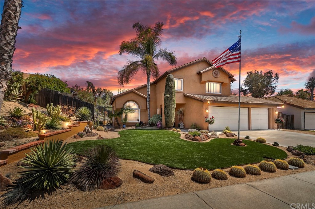 29677 Stonewood Road Temecula, CA 92591 - Photo 1 of 1 Front yard with artificial grass, cacti, sculpted artificial turf surrounded by rock lined planters of drought tolerant plants with palms, all automatically watered by a drip system to each plant.