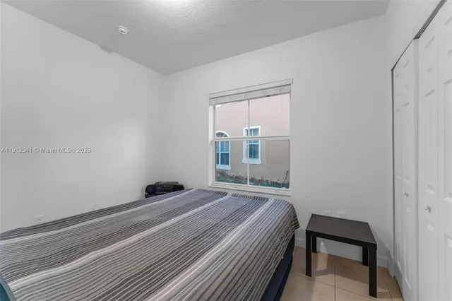 a bedroom with a bed and glass door