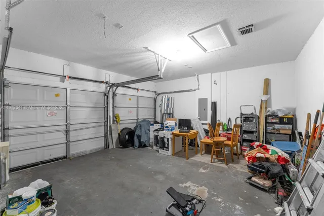 a view of a patio with table and chairs and wooden fence