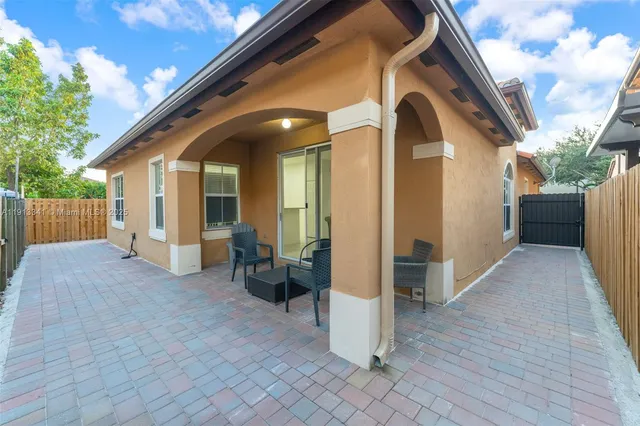 an aerial view of a house with swimming pool and sitting space