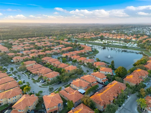 an aerial view of a house with a lake