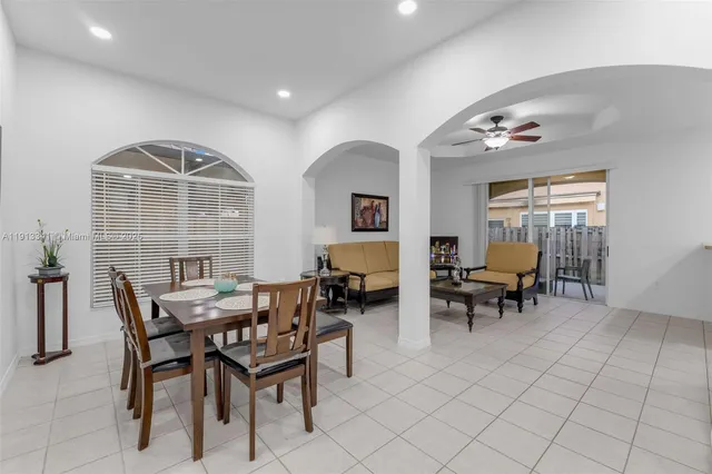a view of a dining room with furniture and a potted plant