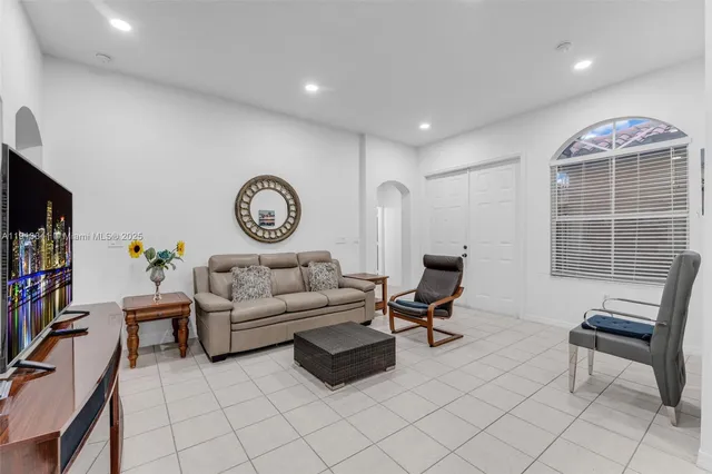 a living room with furniture a clock and a window