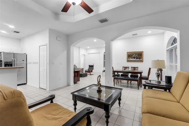 a kitchen with kitchen island a counter top space cabinets and stainless steel appliances