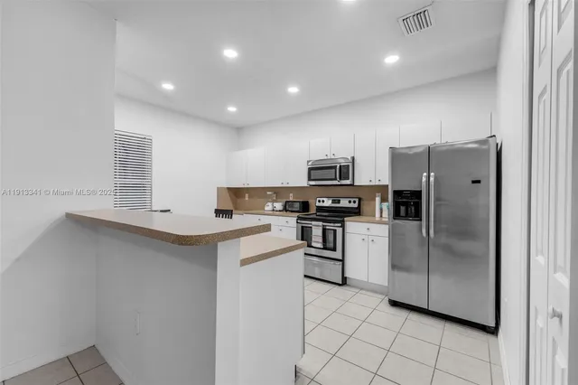 a kitchen that has a sink and a stove in it