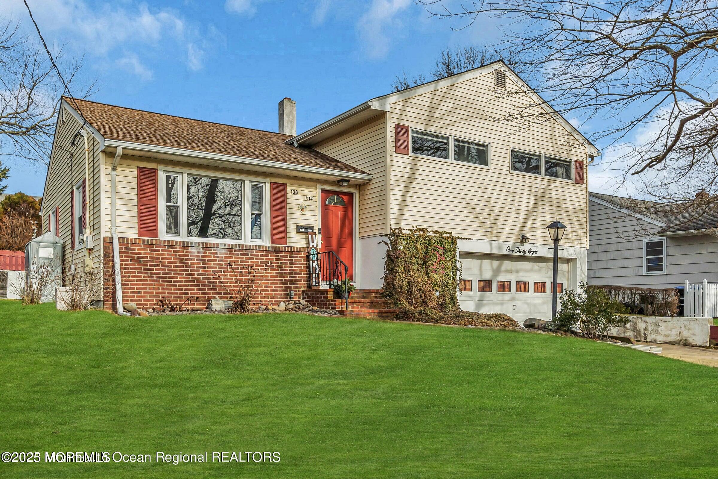 1114 Mohegan Road Manasquan, NJ 08736 - Photo 1 of 28 a front view of a house with a yard and garage