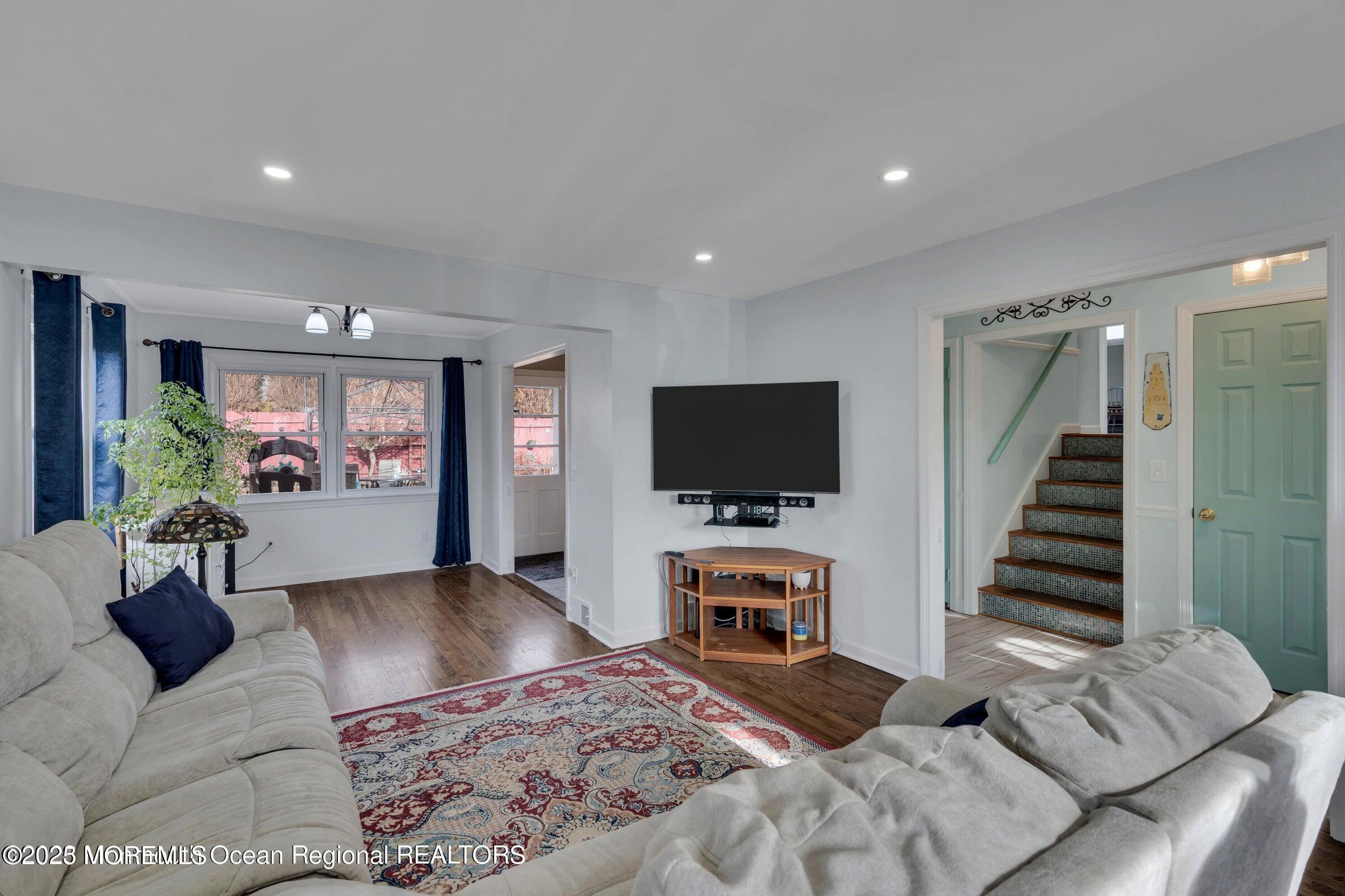 1114 Mohegan Road Manasquan, NJ 08736 - Photo 12 of 28 a living room with furniture and a flat screen tv