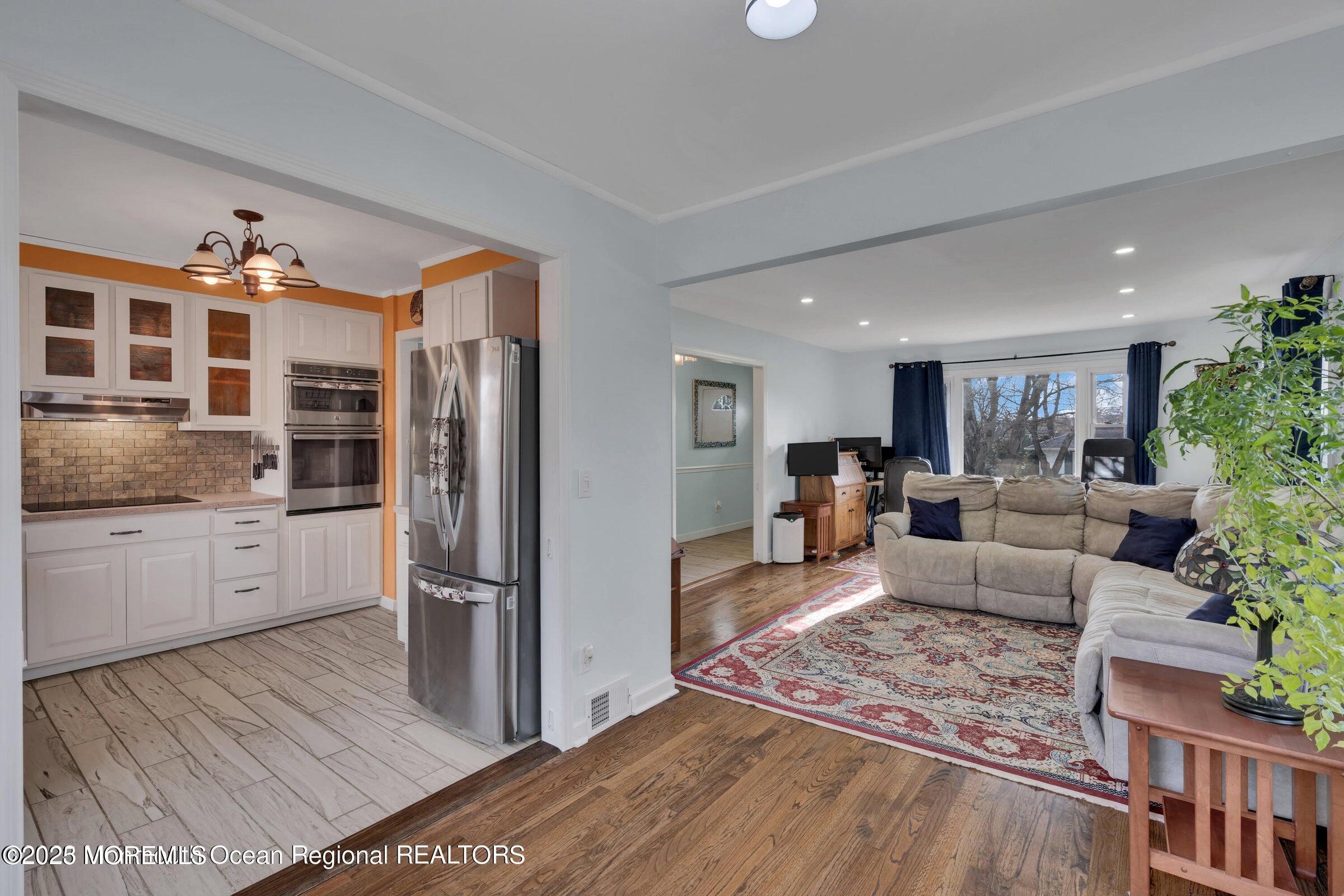 1114 Mohegan Road Manasquan, NJ 08736 - Photo 15 of 28 a living room with furniture or kitchen view and a refrigerator