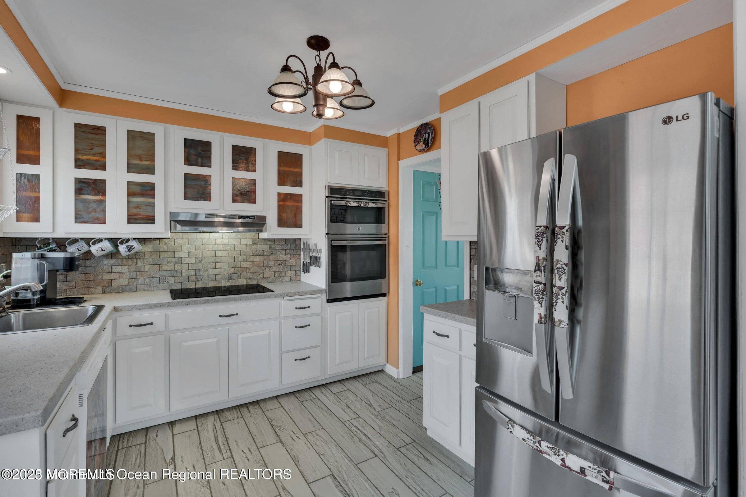 1114 Mohegan Road Manasquan, NJ 08736 - Photo 17 of 28 a kitchen with stainless steel appliances granite countertop a refrigerator and a sink