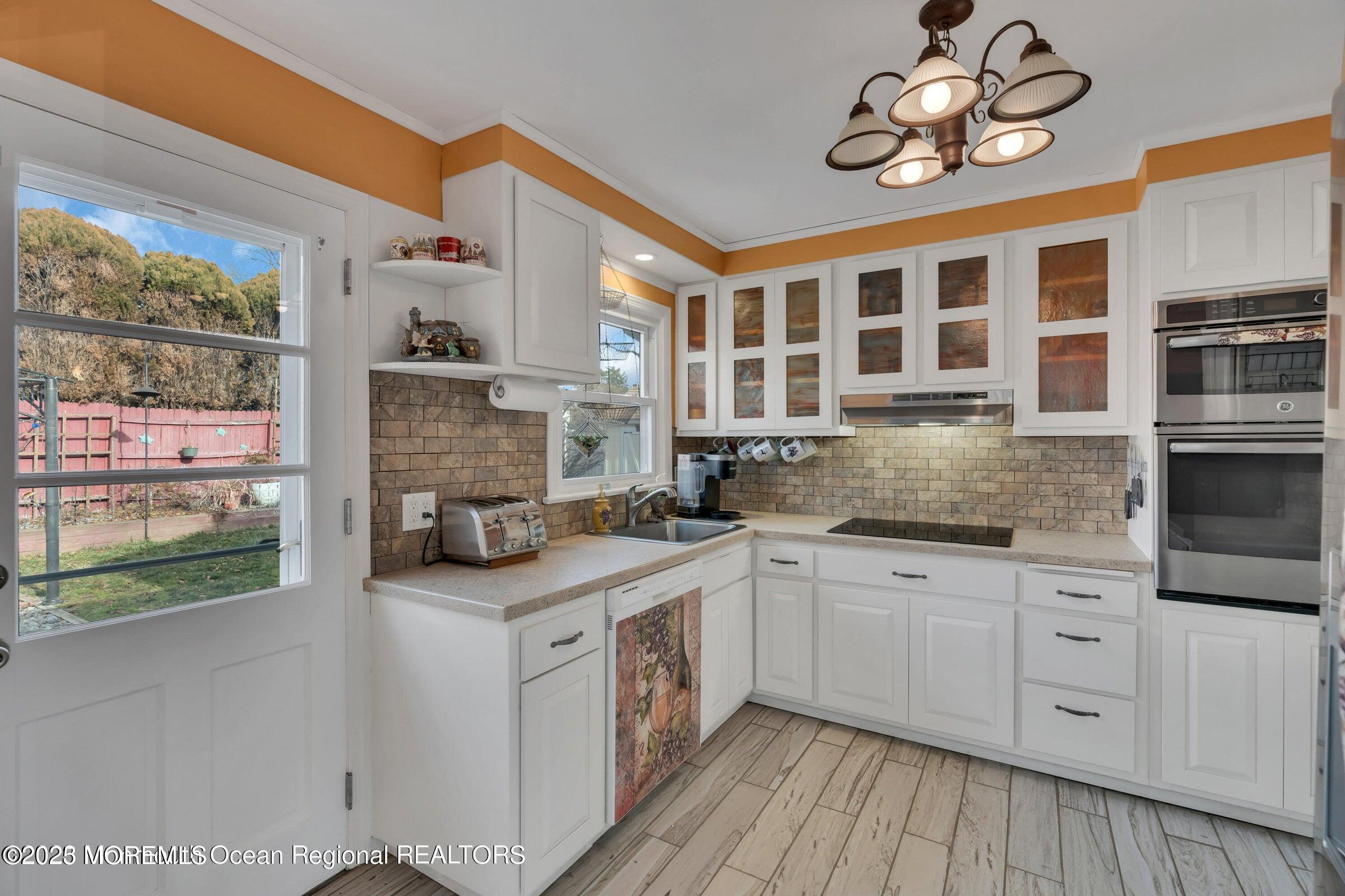 1114 Mohegan Road Manasquan, NJ 08736 - Photo 18 of 28 a kitchen with stainless steel appliances granite countertop a stove and cabinets