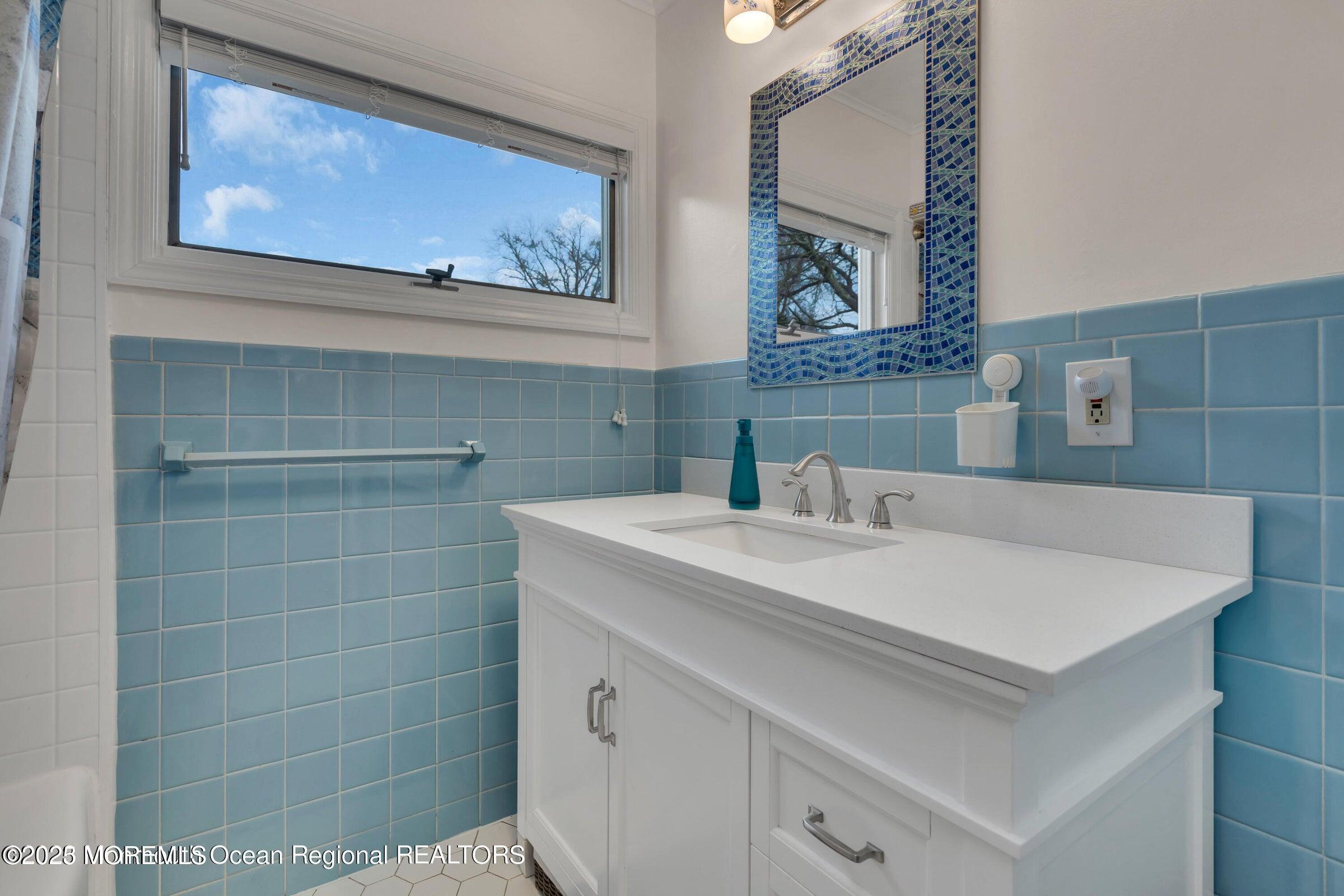 1114 Mohegan Road Manasquan, NJ 08736 - Photo 21 of 28 a bathroom with a sink and a mirror