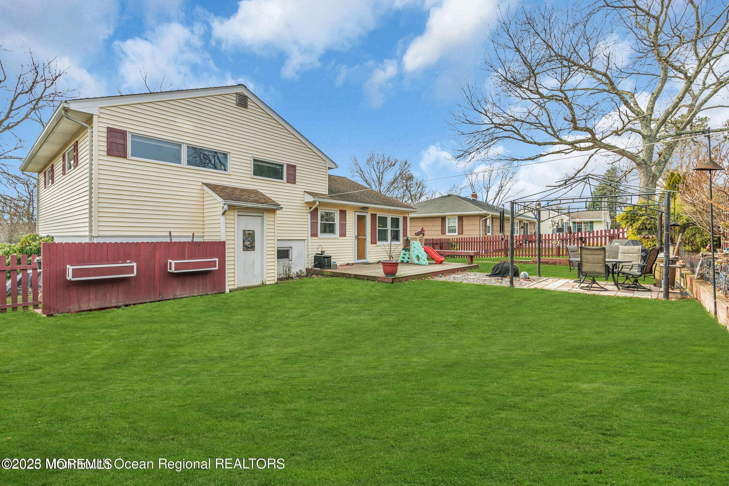 1114 Mohegan Road Manasquan, NJ 08736 - Photo 4 of 28 a front view of a house with a garden