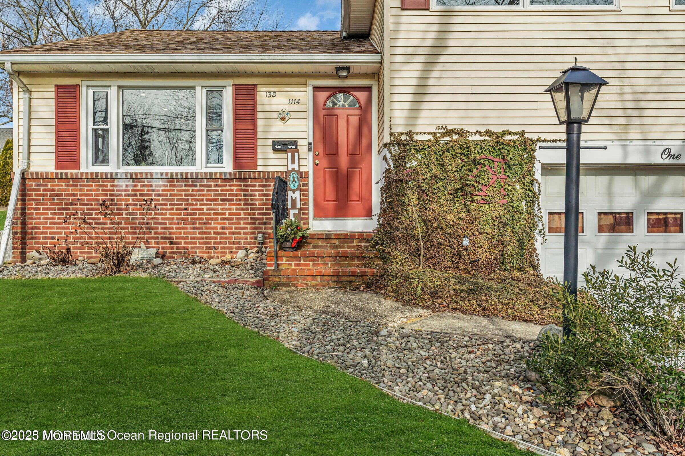 1114 Mohegan Road Manasquan, NJ 08736 - Photo 5 of 28 a front view of a house with a garden