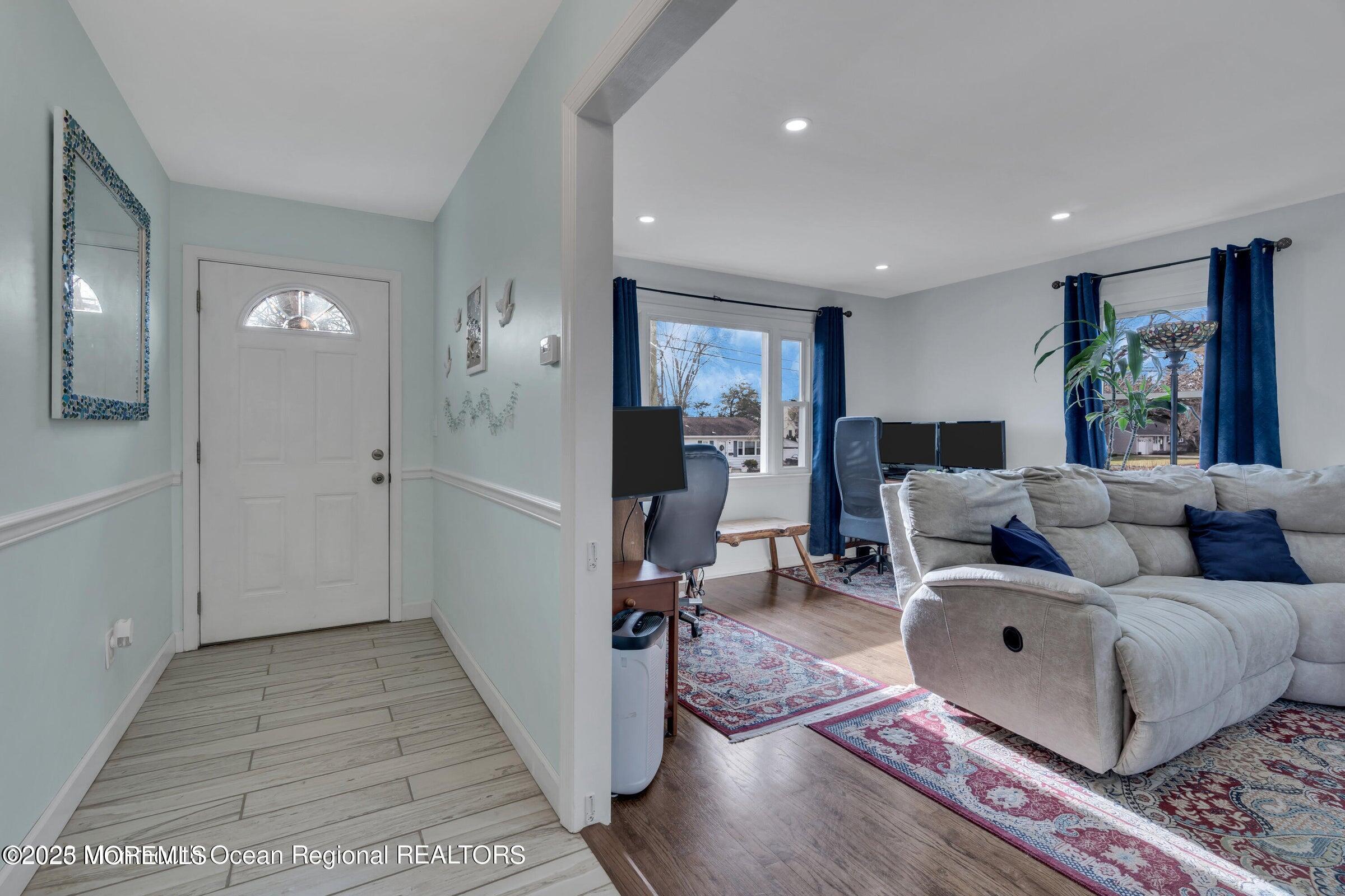 1114 Mohegan Road Manasquan, NJ 08736 - Photo 7 of 28 a living room with furniture and a fireplace