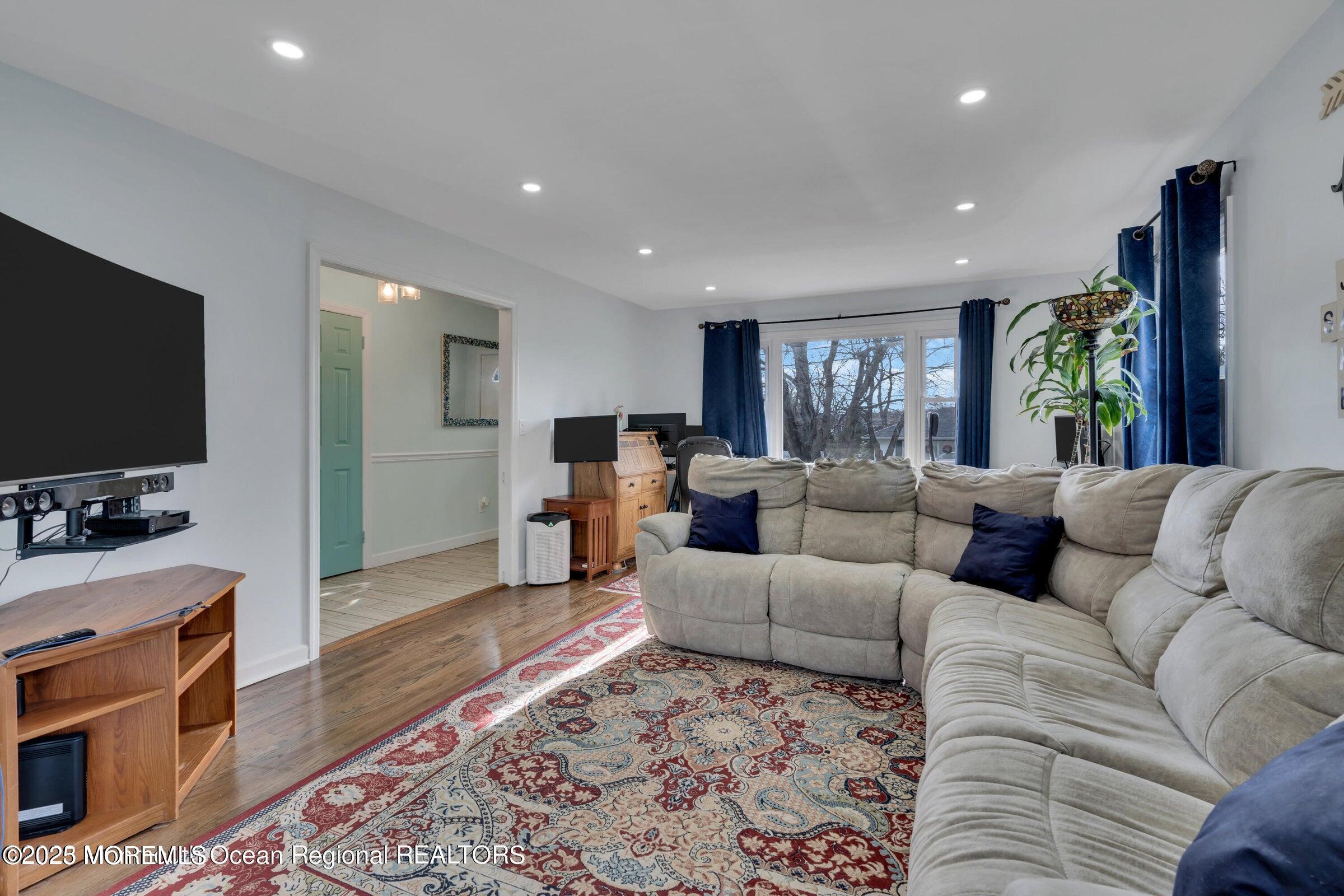 1114 Mohegan Road Manasquan, NJ 08736 - Photo 8 of 28 a living room with furniture and a flat screen tv