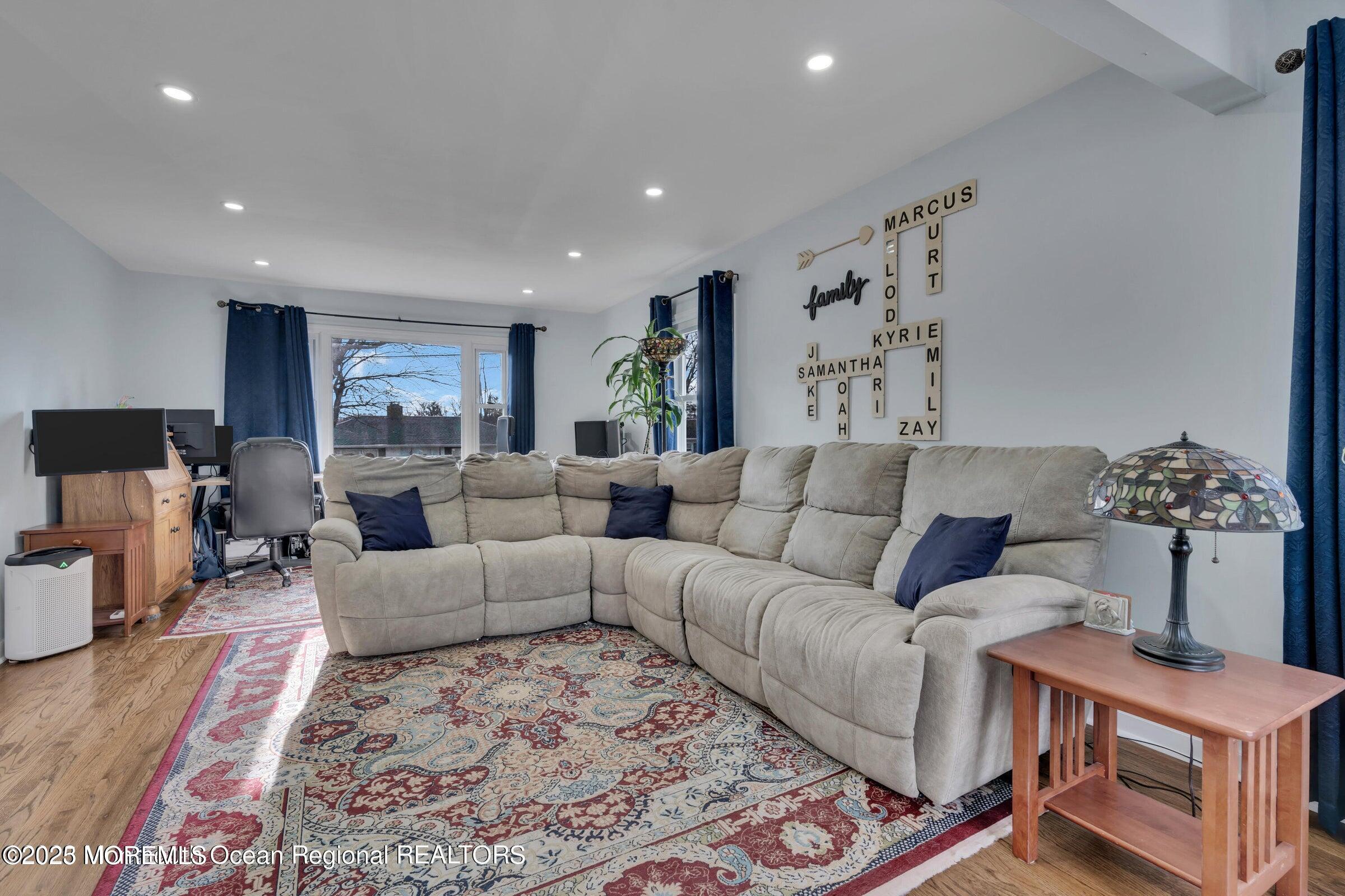 1114 Mohegan Road Manasquan, NJ 08736 - Photo 9 of 28 a living room with furniture and a flat screen tv
