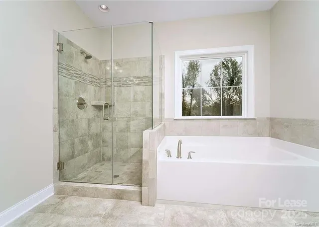 a white bath tub sitting next to a shower