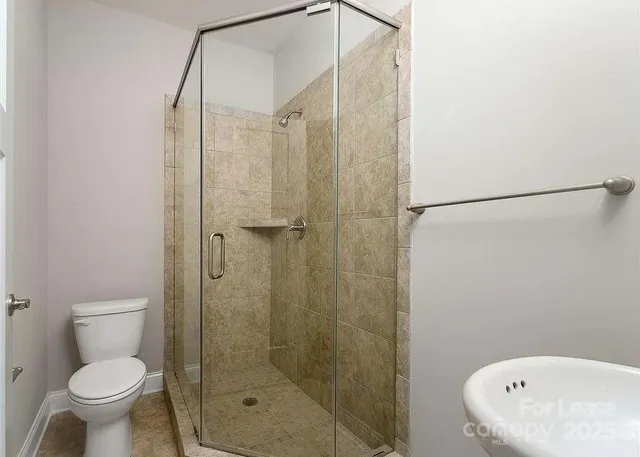a bathroom with a shower and a toilet