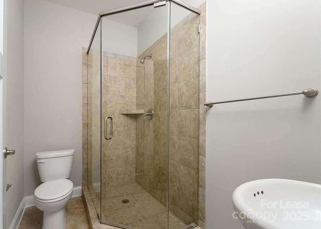 13012 Vermillion Crossing Court Huntersville, NC 28078 - Photo 13 of 18 a bathroom with a shower and a toilet